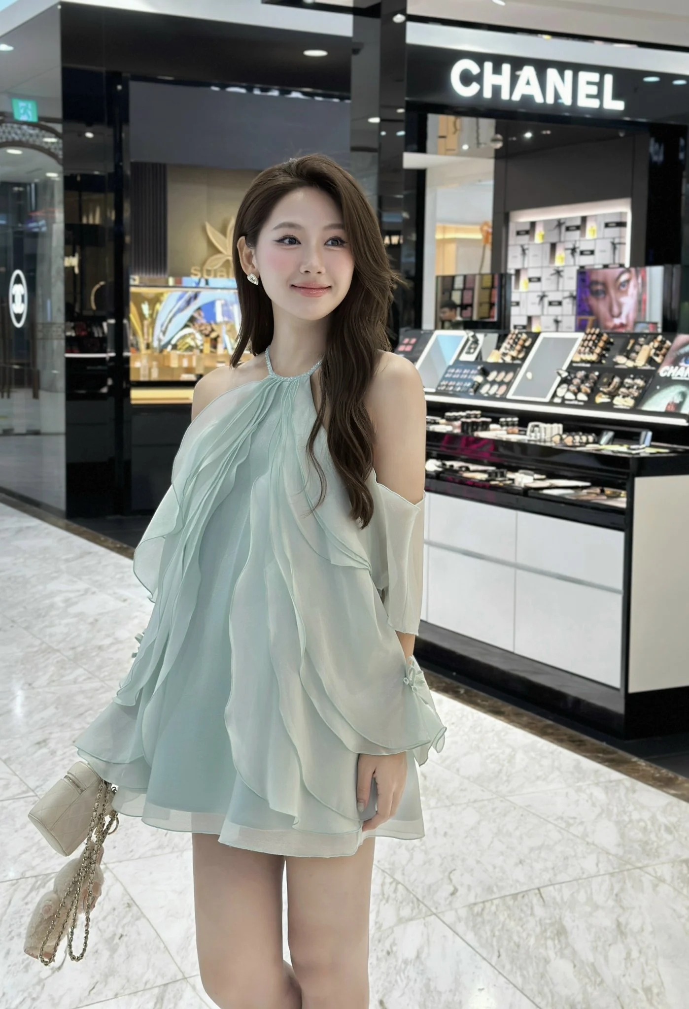 Model wearing a pale green ruffled short dress