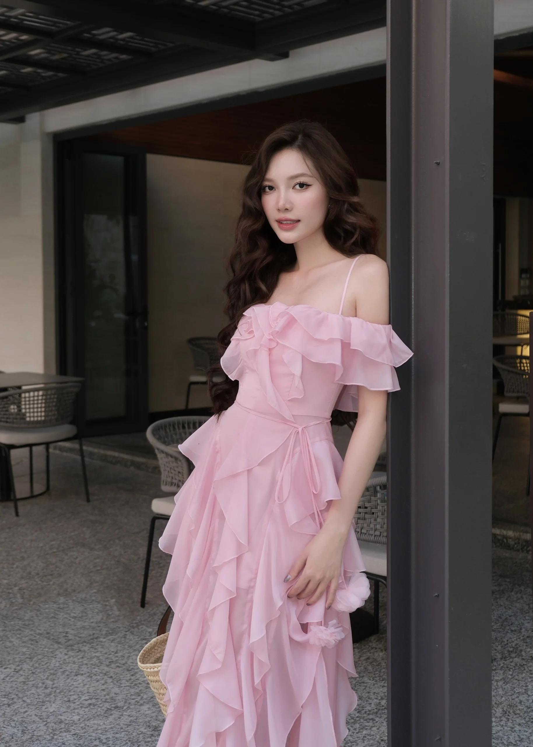 Model wearing a pink off-shoulder ruffled dress