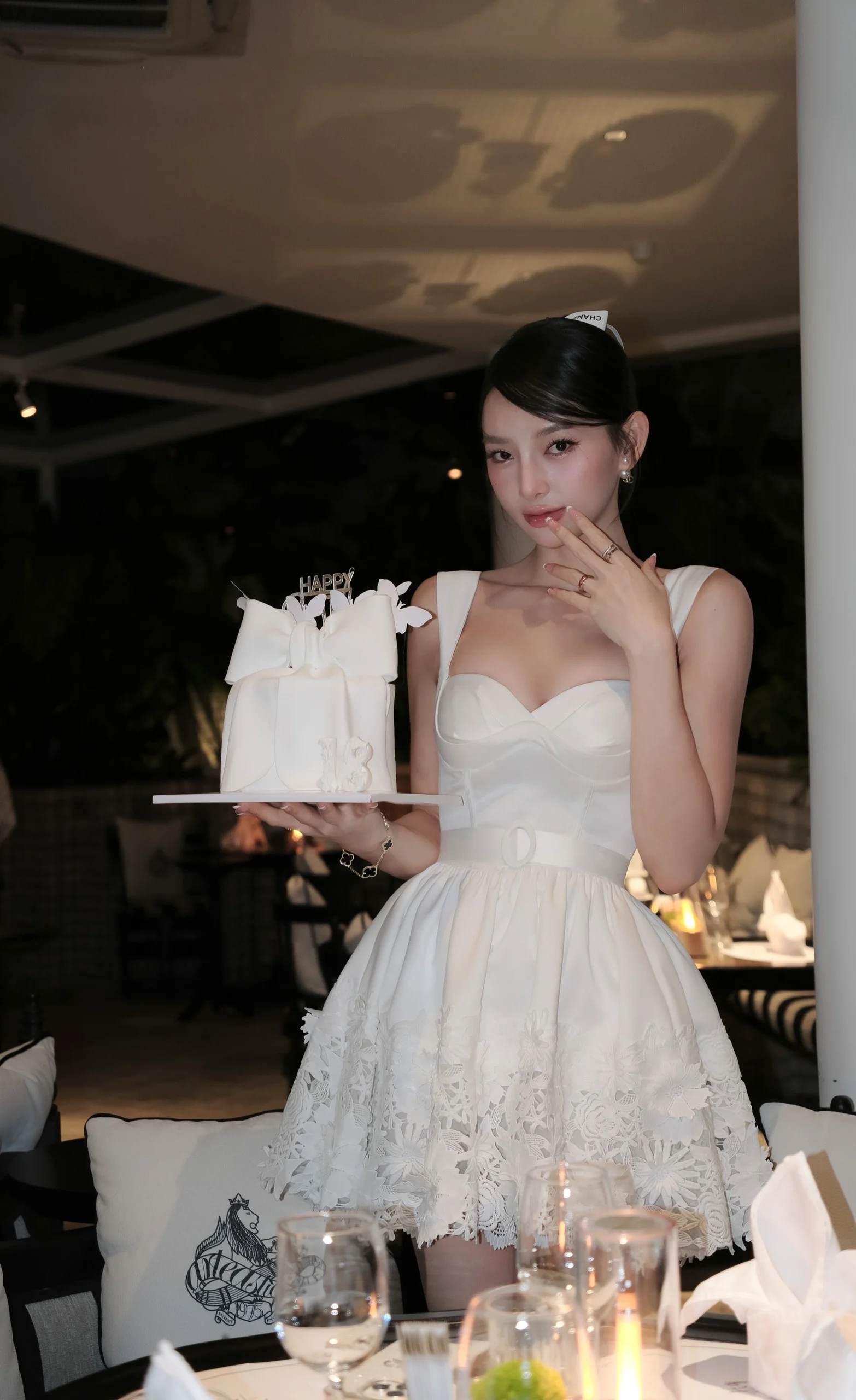 Model wearing a white strapless short dress